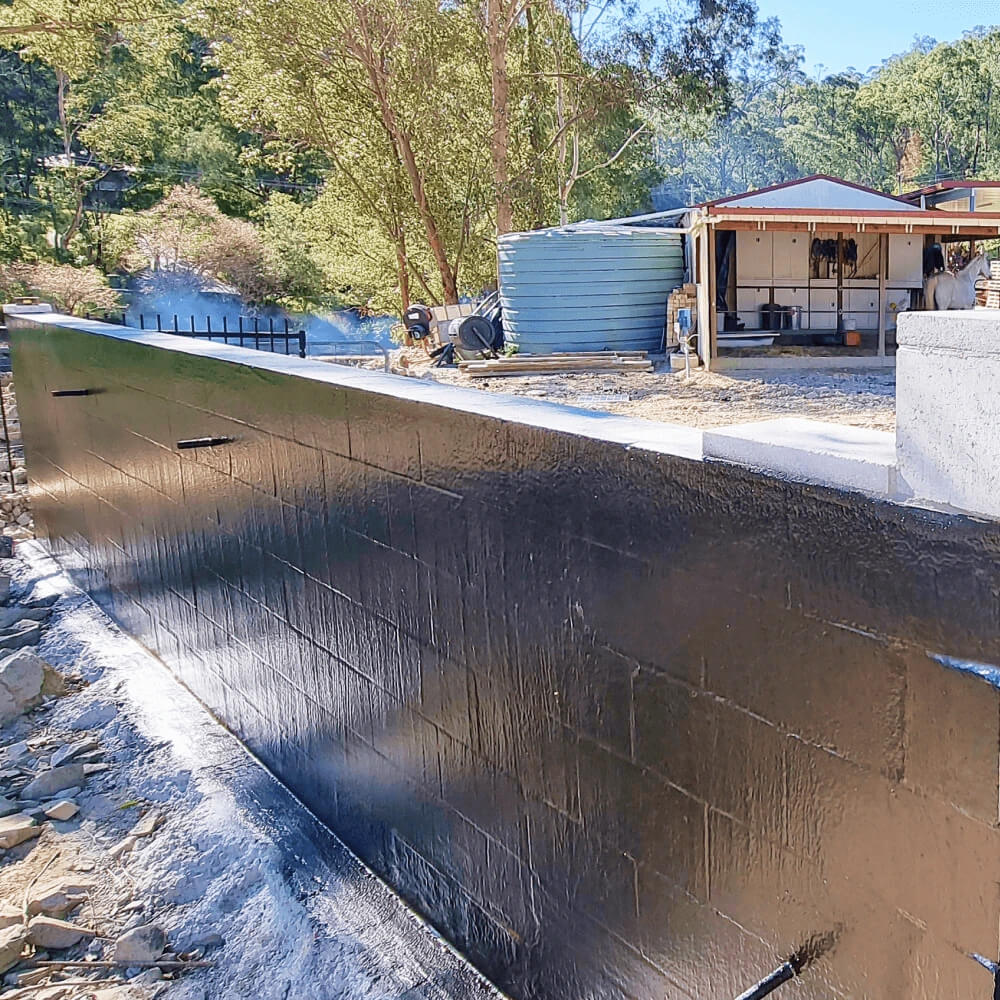 A Picture of a Retaining Wall waterproofed with Liquid Rubber DIY Waterproof Sealant.